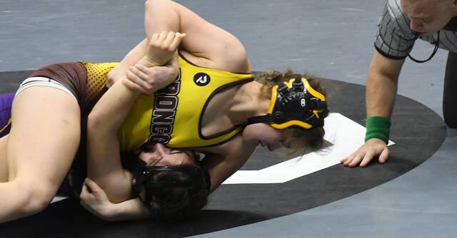 <p>Western Brown’s Abigail Miller (top) gains position against Olive Karam of Warren Champion in the first round of the OHSAA State Wrestling Championships in Columbus. Miller won by pin in 3:27. Photo by Brian S. Peterson</p>