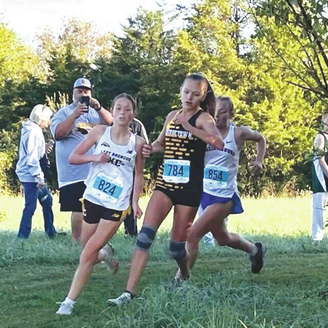 <p>Western Brown freshman Rian Helton leads runners on her way to a first place finish in this year’s Southern Buckeye Athletic/Academic Conference Cross Country Championship Meet on Oct. 11 at Washington Township Park, while following close behind is Georgetown freshman Allie Tolle. Photo provided</p>