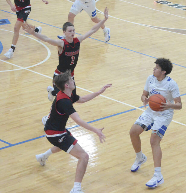 Ripleys Kyler Williams runs into an Eastern trap (Chase Pinkerton and Jaidon Florence) during the Feb. 19 game at Ripley. Photo by Wade Linville